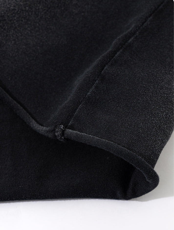 Close-up of T-shirt hem with slightly curled loose edge for casual finish.