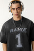 Close-up of model in black 'Raise Fares' tee with metallic headphones and chunky necklace.