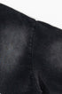 Close-up of fabric showing neat, dense stitching along sleeve seam.