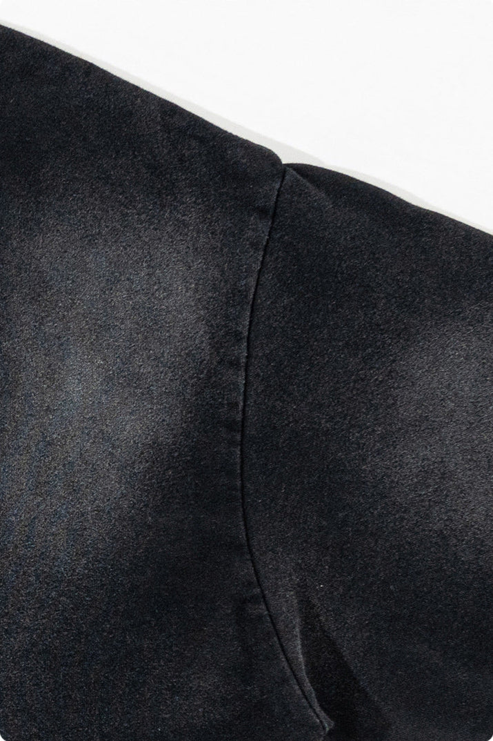 Close-up of fabric showing neat, dense stitching along sleeve seam.