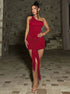 Red one-shoulder mini dress with long front knot and slim bodycon fit in full-length walking pose.