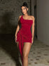 Red velvet one-shoulder mini dress with draped front knot and bodycon fit front view.