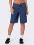 Front view of woman wearing plain dark wash knee-length denim shorts paired with black sneakers and white socks.