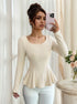 ribbed long sleeve top in cream with U neck and peplum flare, fitted waist, mirror front view