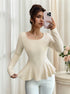 side angle, cream ribbed U neck long sleeve top with fluted peplum and fitted waist