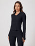 Model in black ribbed yoga jacket with matching pants
