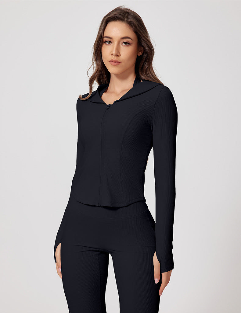 Model in black ribbed yoga jacket with matching pants