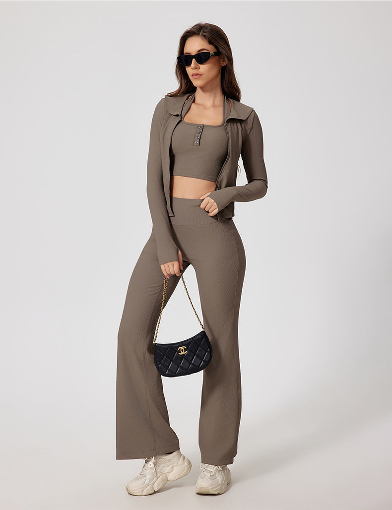 Model in taupe ribbed yoga jacket and pants, styled with black purse