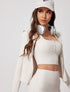 Close-up of white ribbed yoga jacket with button sports bra