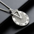 Close-up of silver Roman numeral pendant  with engraved details.