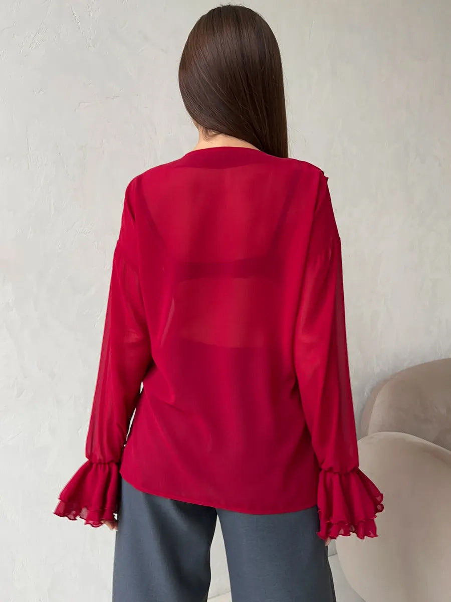 Back view of red sheer blouse with ruffled sleeves