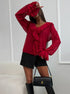 Woman in red ruffle blouse and black mini skirt with knee-high boots