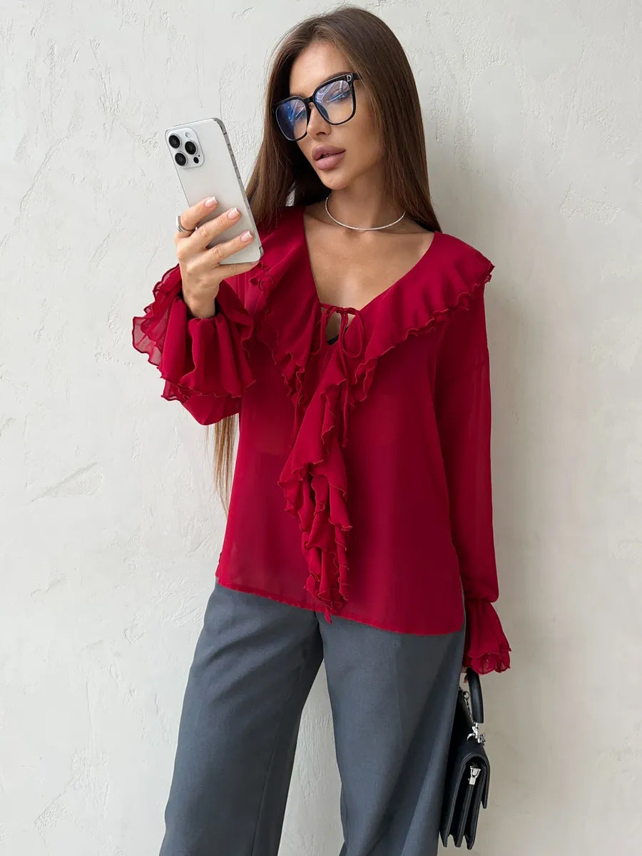 Red ruffle blouse with v-neck styled with gray wide-leg pants