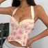 Front view of ivory corset with floral lace-up detail and scalloped hem.