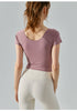Back view of oriental pink yoga top with scoop neck and fitted stretch design.