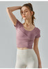 Oriental pink cropped yoga top with cross-pleat detail and slim fit.