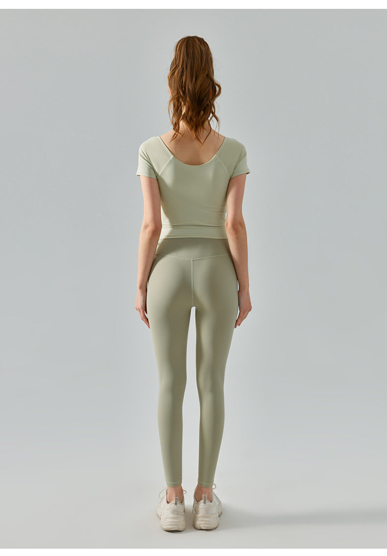 Back view of sisal yoga top with fitted sleeves and wide scoop neck.