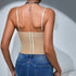Back view of woman in beige corset top and blue jeans, showing hook-and-eye closure.