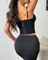 Back view of black corset top with zipper closure and adjustable straps.