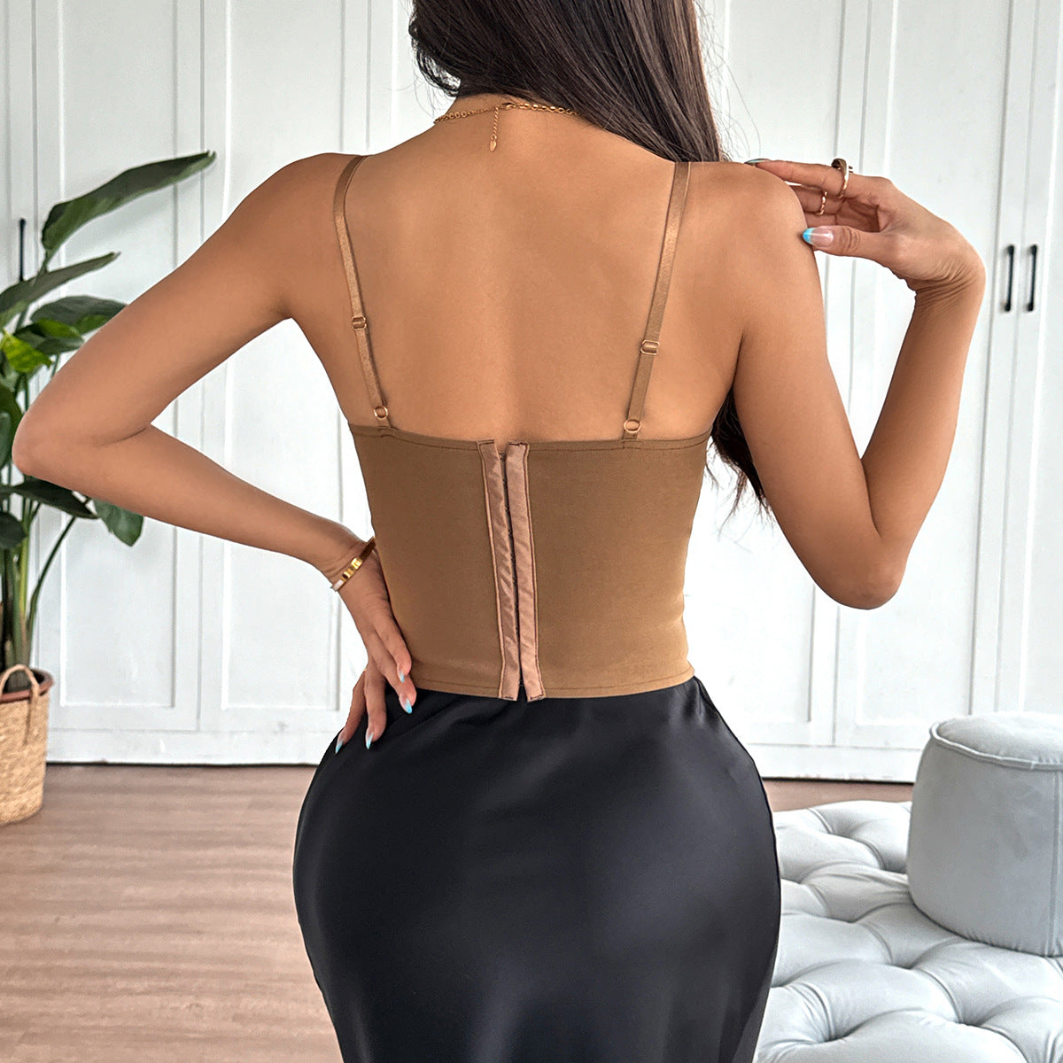 Back view of brown corset top with hook-and-eye closure and adjustable straps.
