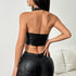 Back view of black halter PU corset top with open back design.