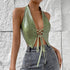 Side view of sage green halter PU corset top paired with high-waisted jeans.