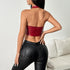 Back view of woman wearing red PU leather halter corset with open back.