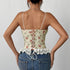 Back view of floral corset top with lace-up closure and lace hem, styled with denim.