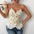 Front view of floral corset top with lace-up closure and lace hem, styled with denim.