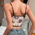 Back view of floral mesh corset with black adjustable straps and no closure.