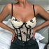 Front view of woman in cream and black floral corset with molded cups.
