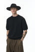 Black short sleeve knit top front view with wide-brim hat