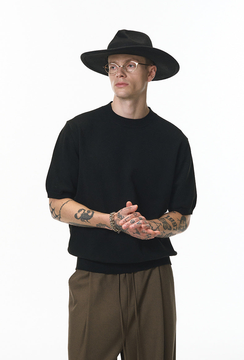 Black short sleeve knit top side view styled with brown pants