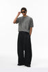 Gray short sleeve knit top styled with black wide-leg pants