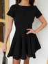 Close-up of fitted bodice and flared skirt of black short sleeve mini dress.