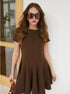 Woman in brown short sleeve flared mini dress with oversized sunglasses.