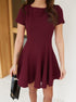 Close-up of burgundy short sleeve mini dress showing fitted waist and flowing skirt.