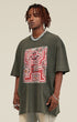 Side angle of model in oversized olive tee with front skeleton graphic.
