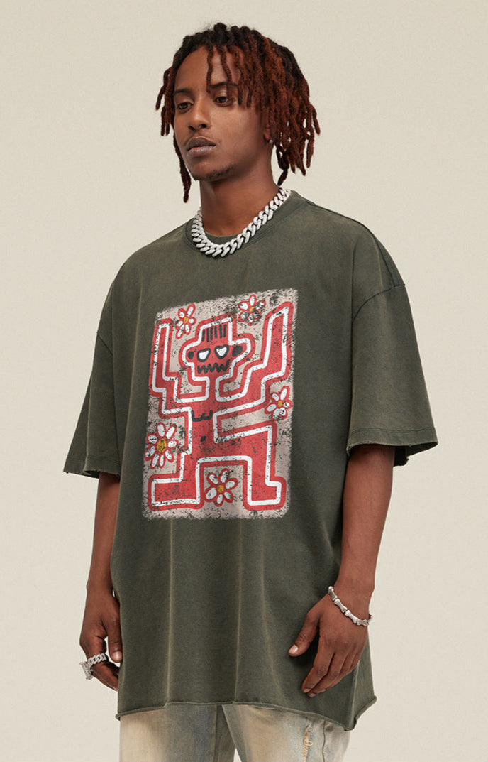 Side angle of model in oversized olive tee with front skeleton graphic.
