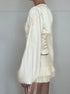 Side view of white satin ruched waist top with long sleeves