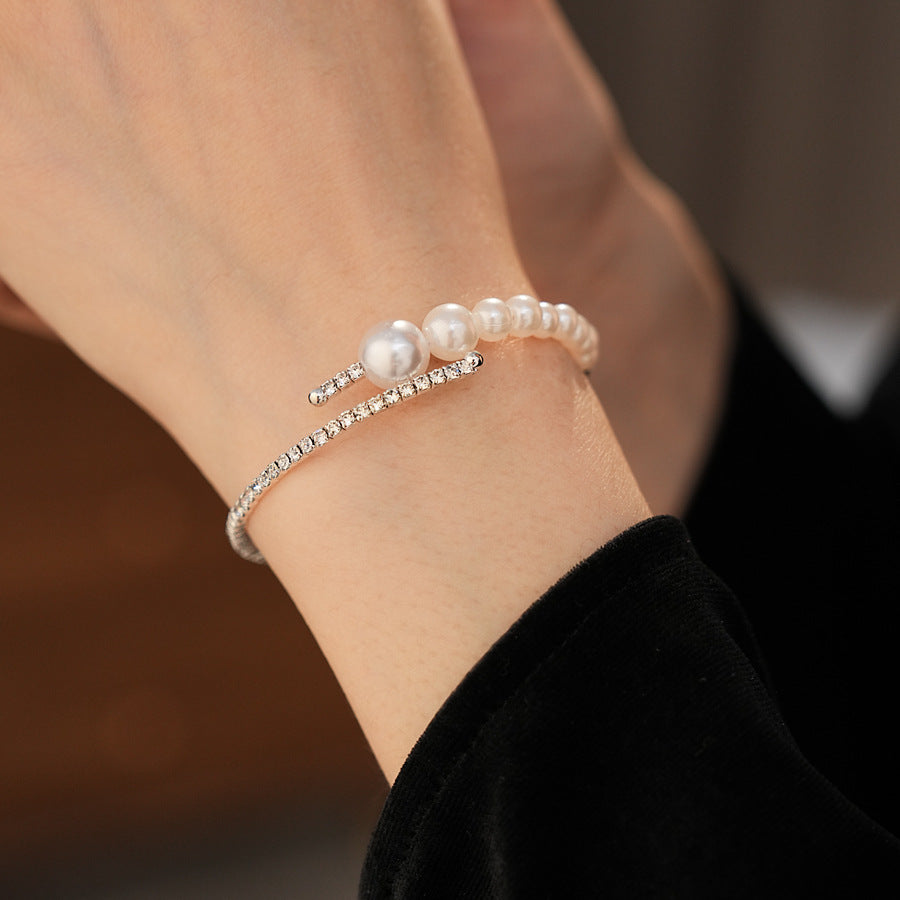 Silver pearl rhinestone bracelet worn on the wrist with hand slightly raised
