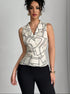 Full-body image of model in abstract print blouse and slim black pants