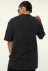 Back view of plain black oversized T-shirt worn by model.