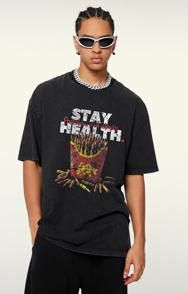 Model in black T-shirt with bullet fries design, posing with one hand hiding.