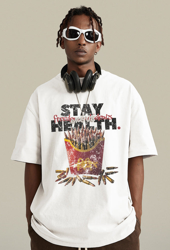Close-up of white graphic T-shirt with bullets in fry container and 'Stay Health.' text.