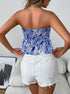 Back view of  blue smocked boho strapless tube top with flare hem in paisley print