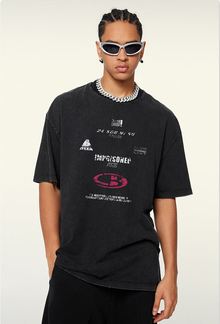Model poses in black tee with printed phrases and layered necklace
