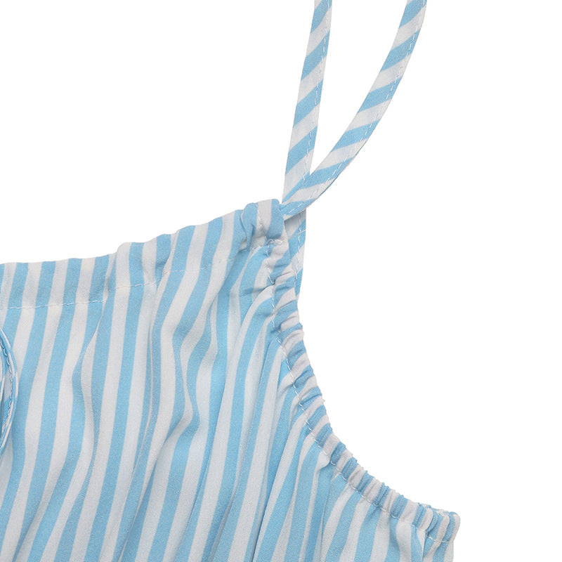 Close-up of adjustable spaghetti strap on blue striped summer dress.