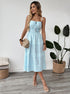 Woman wearing blue and white striped cami midi dress with smocked waist and button front.