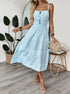 Spinning pose in striped cami dress with smocked waist and decorative buttons.